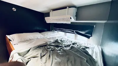 a bed in a room with a blue wall at WinTer Home Stay at S Residences Near Mall of Asia in Manila