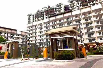 a large apartment building in front of a building at 2BR Fully Air-Conditioned Staycation PLUS Free Parking in Manila