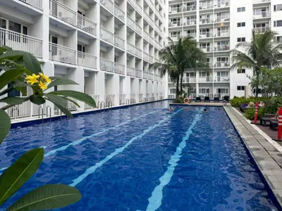a swimming pool in front of a building at GemstoneBR in SMDC Shore Residences in Manila