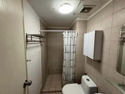 a bathroom with a toilet and a shower at SOHO Central EDSA Shaw Condo Pool front with SMART TV in Manila