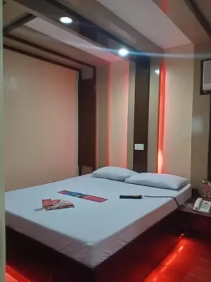 a bedroom with a large bed in a room at Hotel Sogo Edsa Taft in Manila