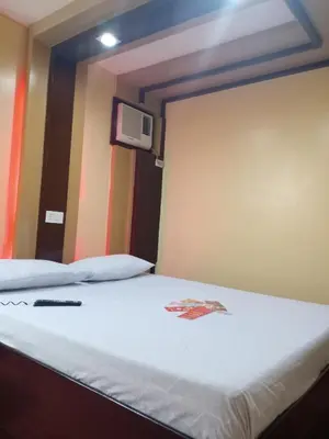 a room with a bed and a tv on the wall at Hotel Sogo Edsa Taft in Manila