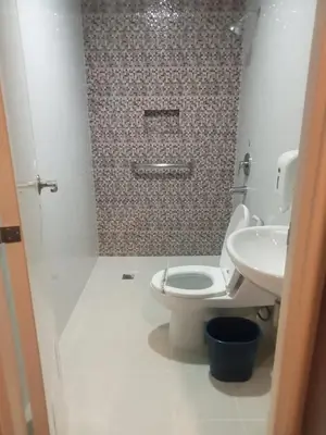 a bathroom with a toilet and a sink at Hotel Sogo Pasay Wood Street in Manila