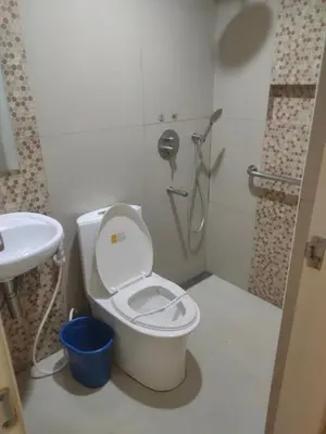 a bathroom with a toilet and a sink and a shower at Hotel Sogo Macapagal in Manila