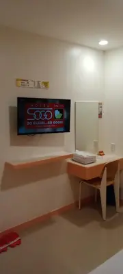 a room with a desk and a sign on the wall at Hotel Sogo Buendia in Manila