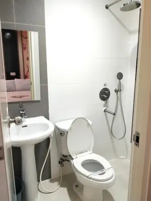 a bathroom with a toilet and a sink at Hotel Sogo Roxas Blvd in Manila