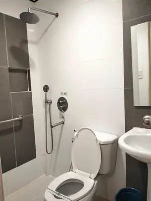 a bathroom with a shower and a toilet and a sink at Hotel Sogo Roxas Blvd in Manila