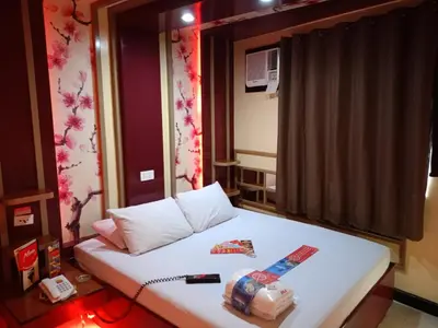 a small room with a bed in a room at Hotel Sogo Yabut in Manila