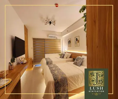 a hotel room with a bed and a ceiling fan at Modern Condo Near Ayala Avenue Makati City CBD at Lush Residences in Manila