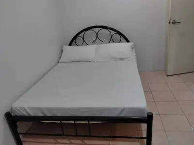 a black and white bed with two pillows on it at San Isidro Cabuyao TRANSIENT in Banlik