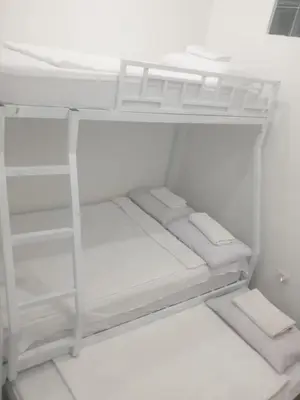 a white closet with white shelves and white towels at Bellas Apartment u1 in Manila