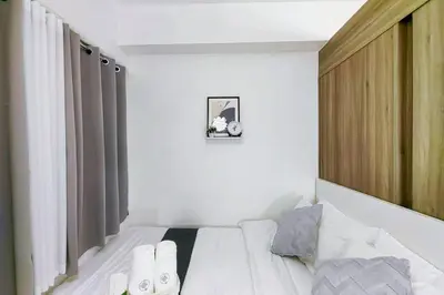 a bedroom with a white bed with white towels on it at 1BR Condotel with Balcony at FAME Residences #FM17 in Manila