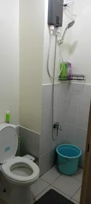 a bathroom with a toilet and a shower at CasaMontero@UrbanDecaTowers EDSA in Manila