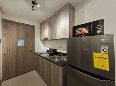 a kitchen with a sink and a counter top at 1BR Condotel with Balcony at FAME Residences #FM21 in Manila