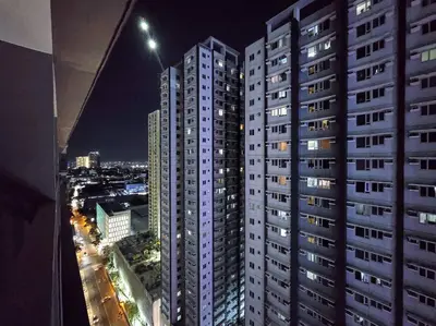 a view of a city at night with tall buildings at 1BR Condotel with Balcony at FAME Residences #FM22 in Manila