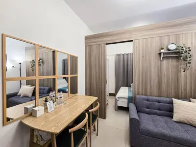 a room with a dining table and a bedroom at 1BR Condotel with Balcony at FAME Residences #FM23 in Manila