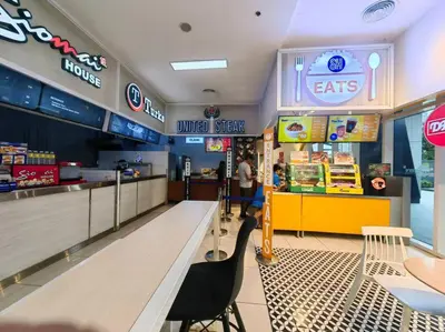 a fast food restaurant with a table and chairs at 1BR Condotel with Balcony at FAME Residences #FM25 in Manila