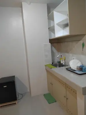 a kitchen with a sink and a counter top at AGB Anchorage Inn in Manila