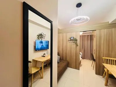 a living room with a table and a dining room at 1BR Condotel with Balcony at FAME Residences #FM27 in Manila