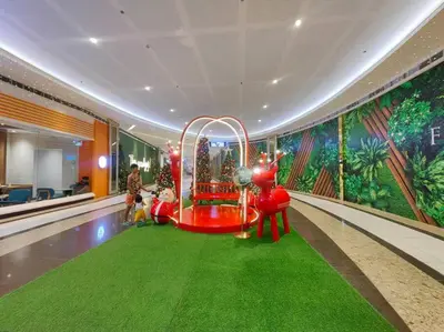 a lobby with a roller coaster in a room with a mural at 1BR Condotel with Balcony at FAME Residences #FM29 in Manila