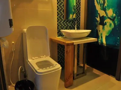 a bathroom with a white toilet and a sink at Hotel Dreamworld Las Pinas in Manila