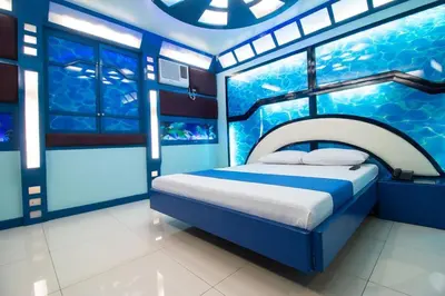 a room with a bed and an aquarium in it at Hotel Dreamworld Las Pinas in Manila