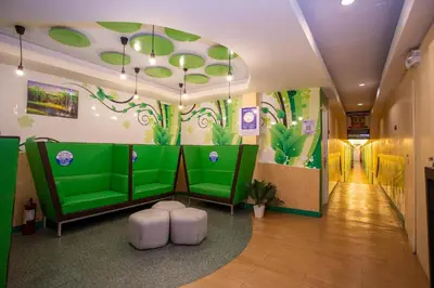 a room with a green wall with plants on it at Hotel Dreamworld Las Pinas in Manila