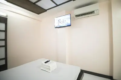 a room with a white table and an air conditioner at Astrotel Calamba in Calamba