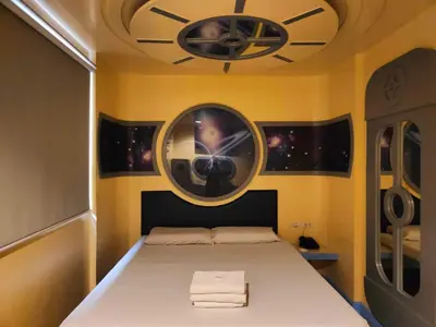 a bedroom with a bed with a clock on the ceiling at Astrotel Guadalupe in Manila