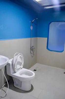 a bathroom with a toilet and a sink at Astrotel Divisoria in Manila