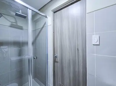 a shower with a glass door in a bathroom at 1BR Condotel with Balcony at FAME Residences #FM30 in Manila