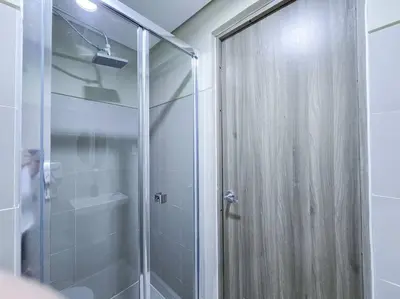 a shower with a glass door in a bathroom at 1BR Condotel with Balcony at FAME Residences #FM32 in Manila