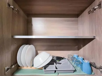 a kitchen with a sink and plates on a shelf at 1BR Condotel with Balcony at FAME Residences #FM33 in Manila