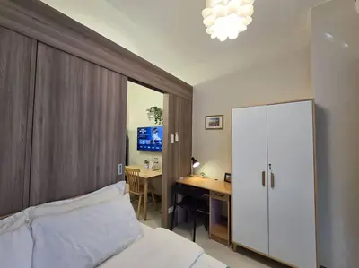 a bedroom with a bed and a desk with a computer at 1BR Condotel with Balcony at FAME Residences #FM33 in Manila