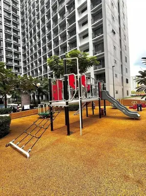 a playground with a slide in a city at JoVis Place Staycation near MOA(Wifi & Netflix) in Manila