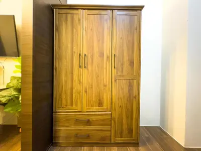 a wooden wardrobe in a room with a tv at 1BR Makati, Air Residences M002 in Manila