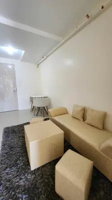 a living room with two beds and a table at URBAN DECA R1125 Ortigas SM EAST in Manila