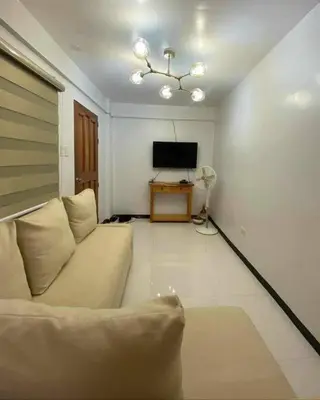 a living room with a couch and a television at House Tahhánne in Amadeo