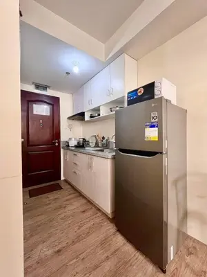 a kitchen with a stainless steel refrigerator and a sink at Condo in silang - near nuvali and tagaytay in Silang