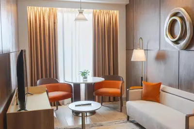 a living room with a couch and a table at Grand Westside Manila Bay in Manila