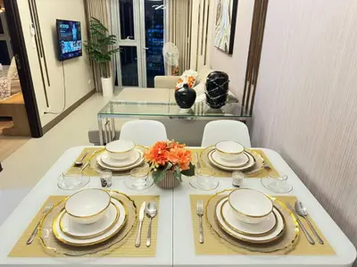 a white table with plates and silverware on it at Executive Stay with Balcony & Malls at Uptown BGC in Manila
