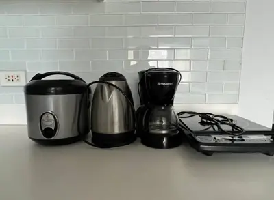 a kitchen counter with a coffee maker and a toaster at Skyloft Acqua Private Residences in Manila