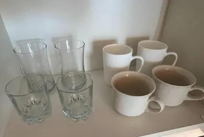 a group of glass vases and cups on a counter at Skyloft Acqua Private Residences in Manila