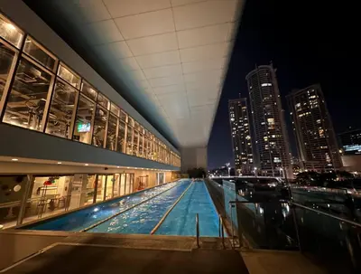 a building with a pool in the middle of a city at night at Skyloft Acqua Private Residences in Manila