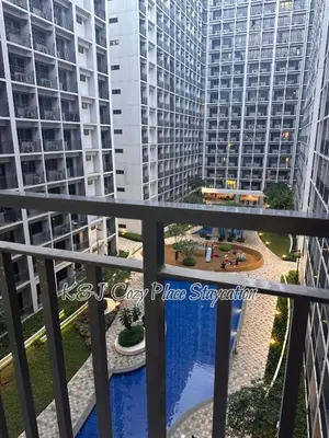 a view from the balcony of a building with tall buildings at Jai Suite K&J Cozy Place Staycation in Manila