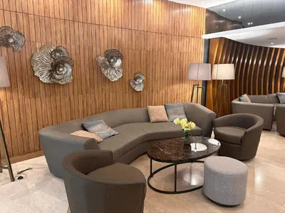 a living room with a couch and chairs and a table at Jai Suite K&J Cozy Place Staycation in Manila
