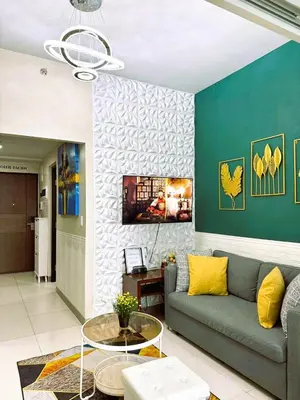 a living room with a couch and a table at Lovely Condo in Uptown, BGC - Soleil Pacific Suite in Manila