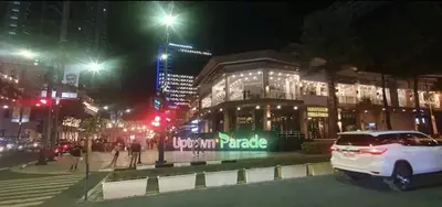 a white car parked in front of a building at night at 2BR at the FORT BGC near Malls, Restaurants & Shops in Manila