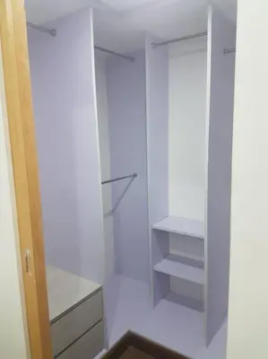 a white walk in closet with white cabinets and shelves at Loft Style Condo Unit in Makati with Netflix WIFI in Manila
