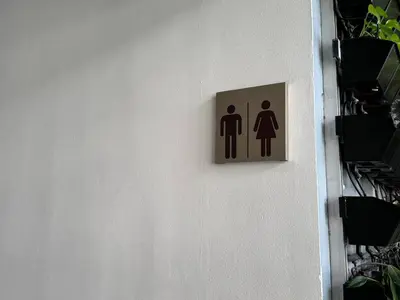 a sign on a wall with a man and a woman at Quiet Condo with Fast WiFi, Own Balcony, Pool and Gym in Manila